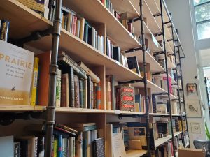 bookshelves inside Massy Books with industrial piping